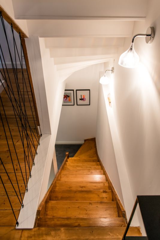 il s'agit d'une cage d'escalier menant à un sous sol, création d'une trémie, isolation des parois, garde-corps graphique en corde de bateau, éclairage par applique E' Kartell